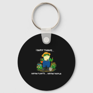 Bury things maybe plants maybe people funny frog key ring