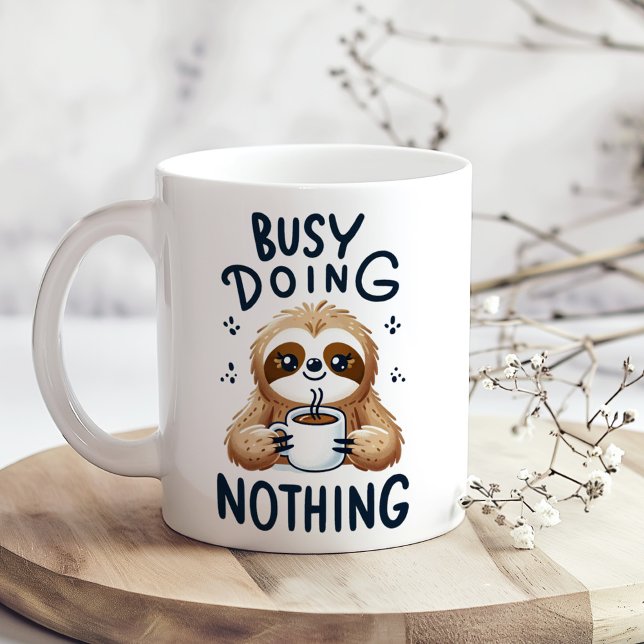"Busy Doing Nothing" Cute Funny Sarcastic Sloth Coffee Mug ("Busy Doing Nothing" Cute Funny Sarcastic Sloth Coffee Mug on a boho kitchen table with tiny flowers)