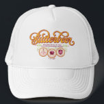 BUTTERBEER™ Available At Wizarding Taverns Trucker Hat<br><div class="desc">Raise a glass to the wizarding world with this charming Butterbeer™ design! Featuring elegant, swirling typography and a warm, vintage-inspired color palette, this artwork celebrates the most beloved drink in magical history. Accented with playful details and references to iconic wizarding taverns like the Three Broomsticks™, the Leaky Cauldron™, and the...</div>