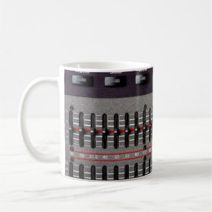 Buttons on a sound mixer in a recording studio. coffee mug