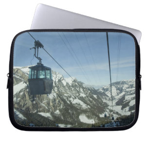 cable cars travelling through snowy mountainous laptop sleeve