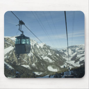 cable cars travelling through snowy mountainous mouse pad