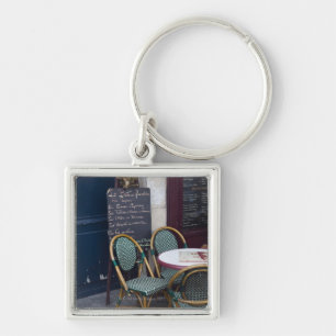 Cafe table with cane chairs in Paris, France Key Ring
