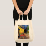 Cafe Terrace at Night by Vincent van Gogh Tote Bag<br><div class="desc">Cafe Terrace on the Place du Forum by Vincent van Gogh is a vintage fine art post impressionism architectural cityscape painting. An exterior view of a restaurant with tables, chairs, waiters, and people dining. A beautiful night with stars in the sky in Arles, France. About the artist: Vincent Willem van...</div>