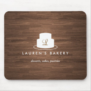 Cake Monogram Logo in White on Brown Woodgrain Mouse Pad