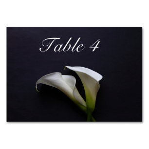 Calla lilies on a dark background table number