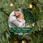 Calligraphy Our First Christmas Couple Green Ceramic Ornament<br><div class="desc">Elegant Calligraphy Script Our First Christmas Couple Photo Green Ornament with Snowflakes back</div>