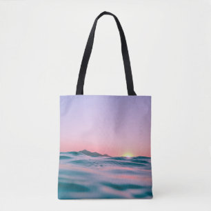 Calm body of water during golden hour tote bag