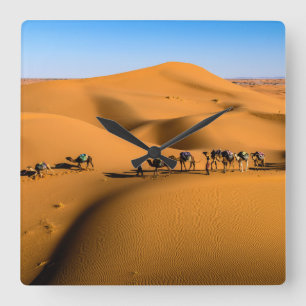camels on desert under blue sky square wall clock