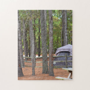 Campground with tent and fence in woods jigsaw puzzle