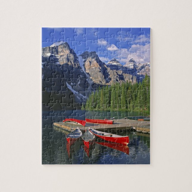 Canada, Alberta, Moraine Lake. Red canoes await Jigsaw Puzzle (Vertical)