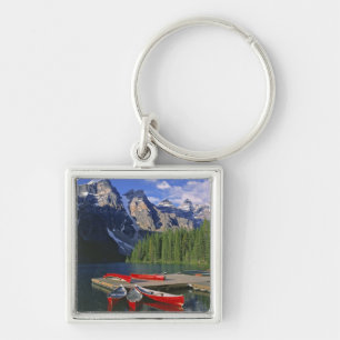 Canada, Alberta, Moraine Lake. Red canoes await Key Ring