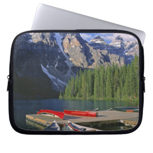 Canada, Alberta, Moraine Lake. Red canoes await Laptop Sleeve