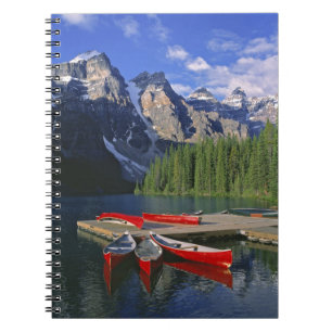 Canada, Alberta, Moraine Lake. Red canoes await Notebook