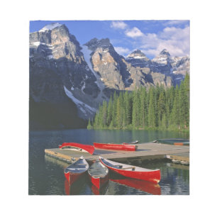 Canada, Alberta, Moraine Lake. Red canoes await Notepad