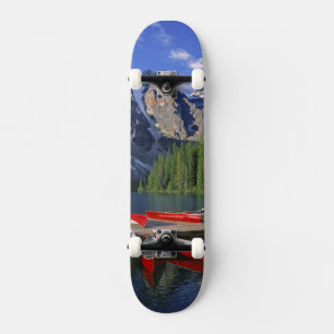 Canada, Alberta, Moraine Lake. Red canoes await Skateboard