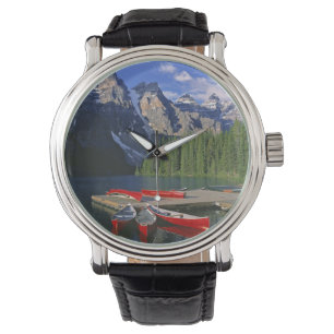 Canada, Alberta, Moraine Lake. Red canoes await Watch