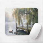 Canada Geese on a Misty Lake Mouse Pad<br><div class="desc">A tranquil lake features a rustic wooden dock beneath elegant willow branches in the mist,  while two Canada geese glide across the still water,  creating gentle ripples behind them</div>