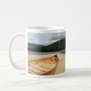 Canoe on Beach by Lake Coffee Mug