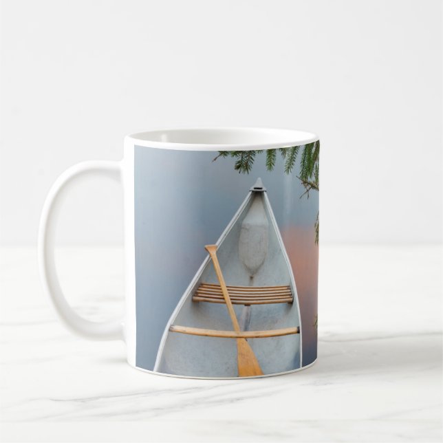Canoe on lake at sunset, Canada Coffee Mug (Left)