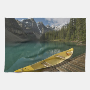 Canoe parked at a dock along Moraine Lake, Banff Tea Towel