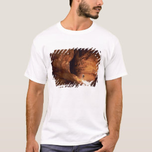 Canyoneer illuminated in the depths of a narrow T-Shirt