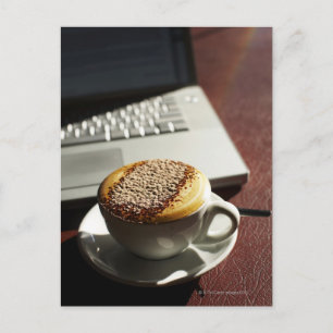 Cappuccino in front of laptop postcard