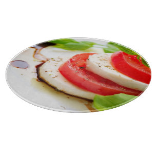 Caprese Salad. Tomato and Mozzarella slices Cutting Board
