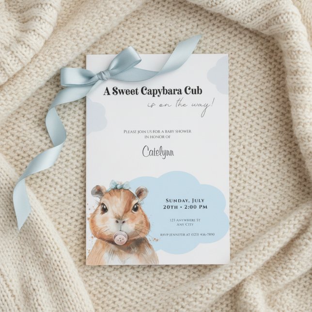 Capybara Baby Shower • Blue Bow Theme Invitation (Baby shower invitation with capybara and blue bow on cream knitted blanket, soft neutral tones.)