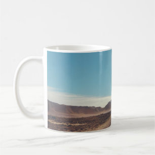 Car on black asphalt road coffee mug