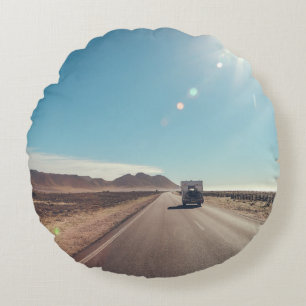 Car on black asphalt road round cushion
