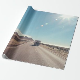 Car on black asphalt road wrapping paper