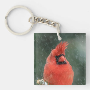 Cardinal in a pine tree during a snow storm key ring