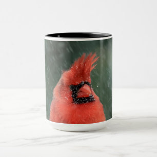 Cardinal in a pine tree during a snow storm mug