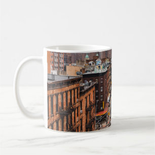 CARS ON ROAD BETWEEN HIGH RISE BUILDINGS DURING DA COFFEE MUG