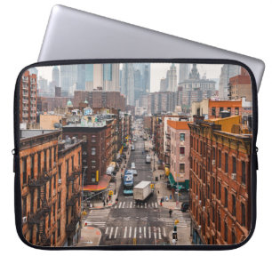 CARS ON ROAD BETWEEN HIGH RISE BUILDINGS DURING DA LAPTOP SLEEVE