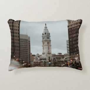 CARS ON ROAD NEAR HIGH RISE BUILDINGS DURING DAYTI DECORATIVE CUSHION