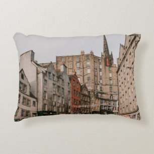 CARS PARKED BESIDE BROWN CONCRETE BUILDING DURING DECORATIVE CUSHION