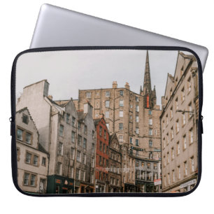 CARS PARKED BESIDE BROWN CONCRETE BUILDING DURING  LAPTOP SLEEVE