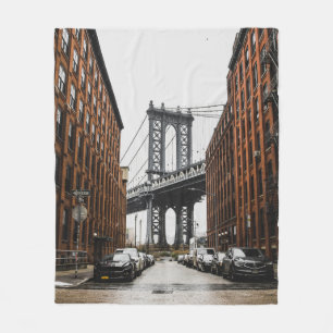 CARS PARKED NEAR BROWN BUILDING FLEECE BLANKET