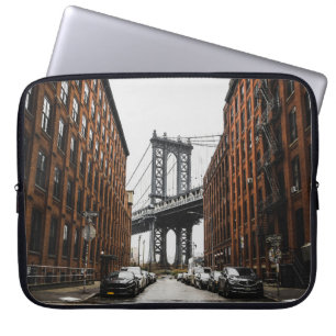 CARS PARKED NEAR BROWN BUILDING LAPTOP SLEEVE