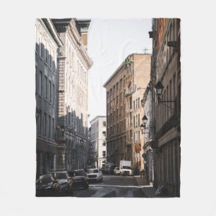 CARS PARKED ON SIDE OF THE ROAD IN BETWEEN BUILDIN FLEECE BLANKET
