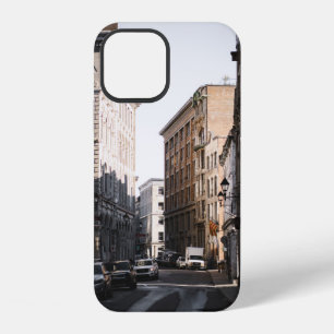 CARS PARKED ON SIDE OF THE ROAD IN BETWEEN BUILDIN iPhone 12 CASE