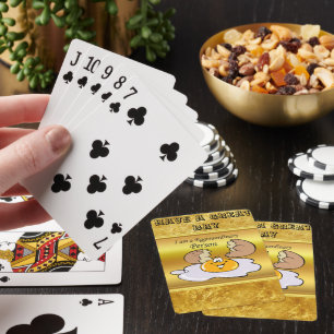 cartoon character fried egg with big smile playing cards