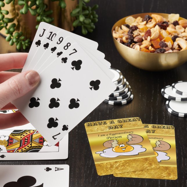 cartoon character fried egg with big smile playing cards (In Situ)