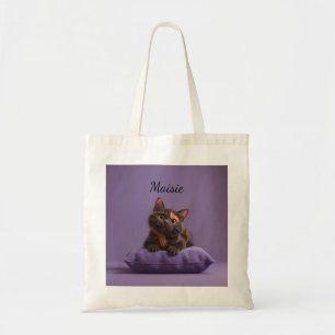 Cartoon Tortoiseshell Kitten on Purple Cushion Tote Bag