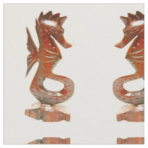 carved wood seahorses on white fabric