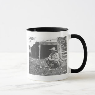 Cat eating out of a coffee can. mug