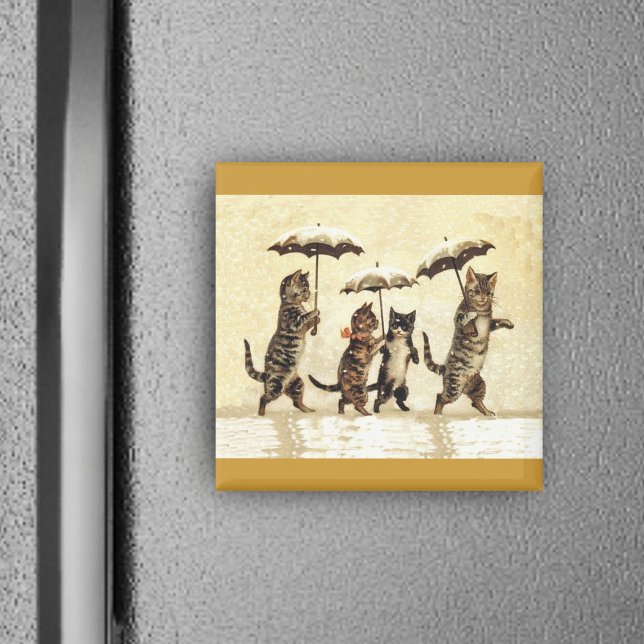 Cat Family With Umbrellas Walking in Snow Magnet (Four brown cats walking upright in snow with umbrellas on yellow square magnet.)