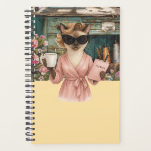 Cat female is holding daily planner